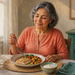 Mujer mayor sentada a la mesa comiendo un plato con pescado, lentejas y verduras, acompañado de agua y un cuenco de yogur.